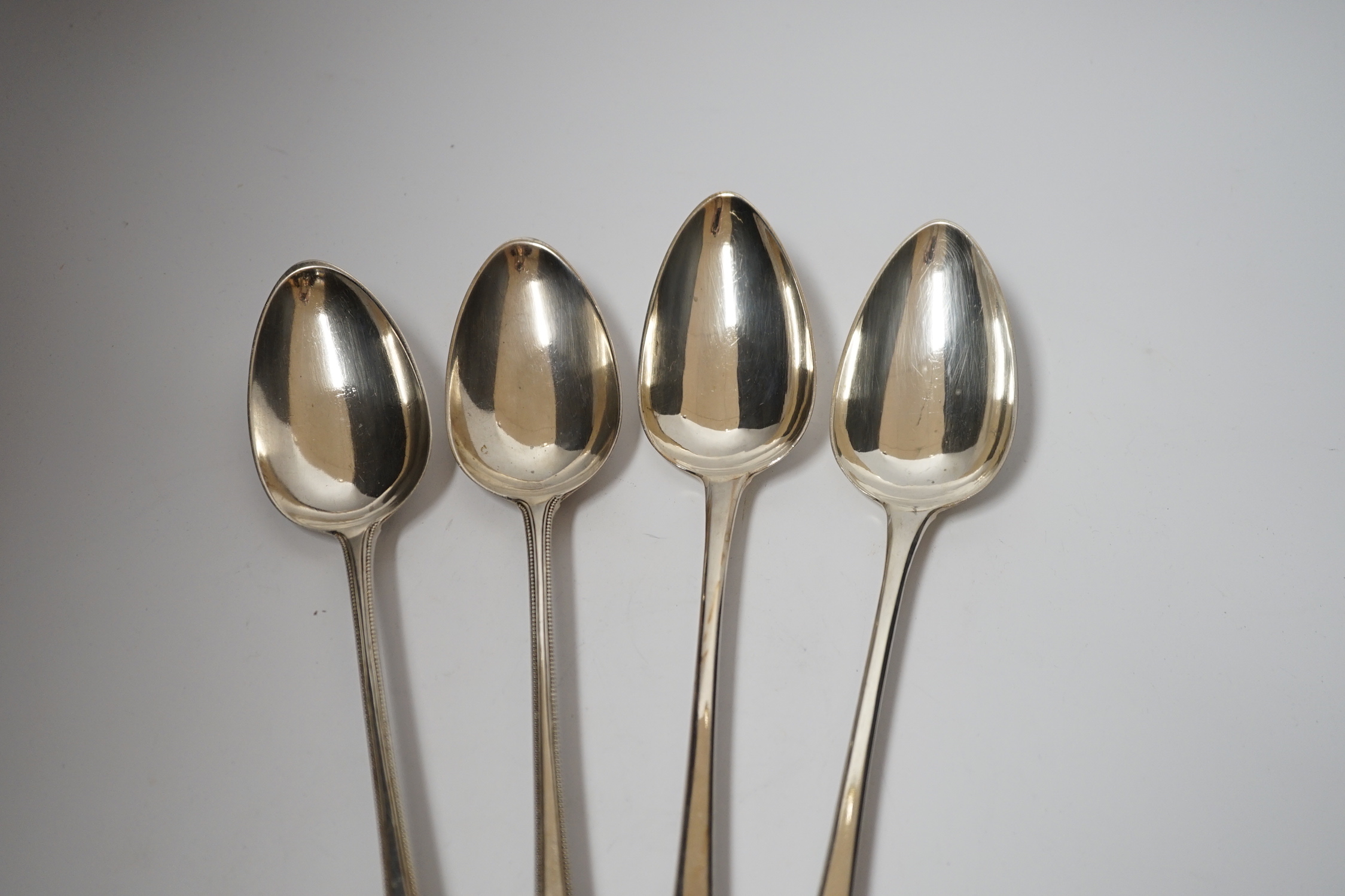 A pair of George III silver beaded Old English pattern basting spoons, George Smith III, London, 1785, 29.5cm and a later silver Old English pattern pair by Peter & William Bateman, 15oz.